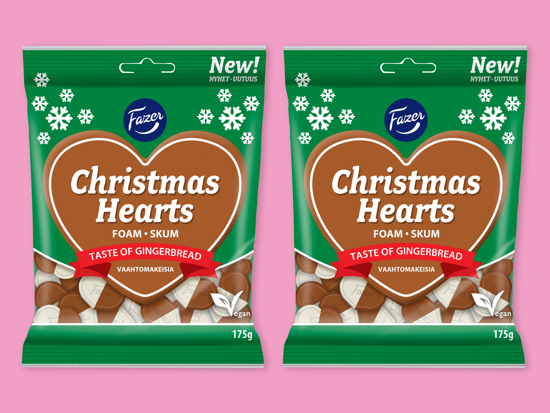 Christmas Hearts från Fazer, två påsar bredvid varandra mot rosa bakgrund.