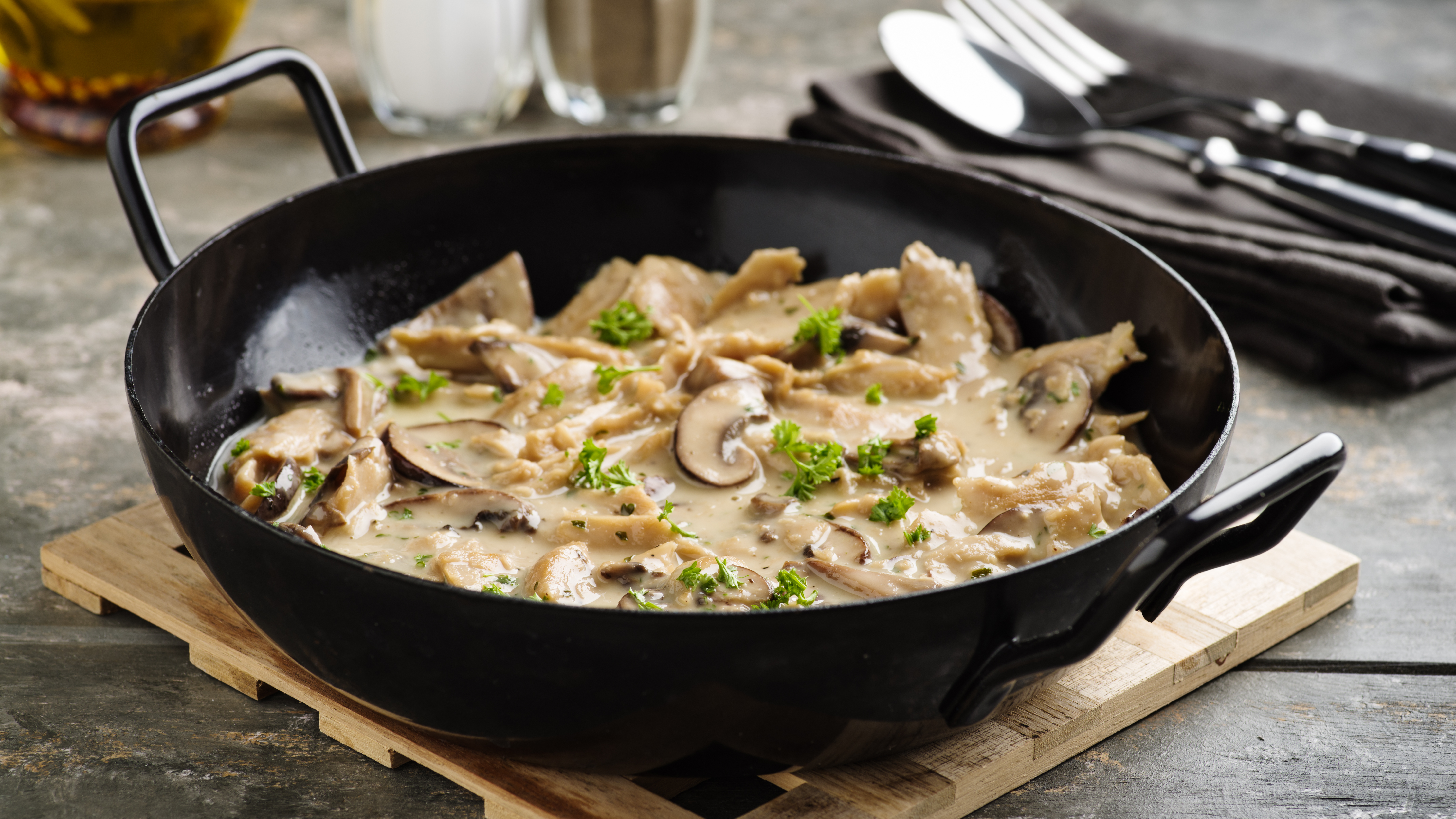 Vegan soy meat stripes and mushrooms in creamy sauce