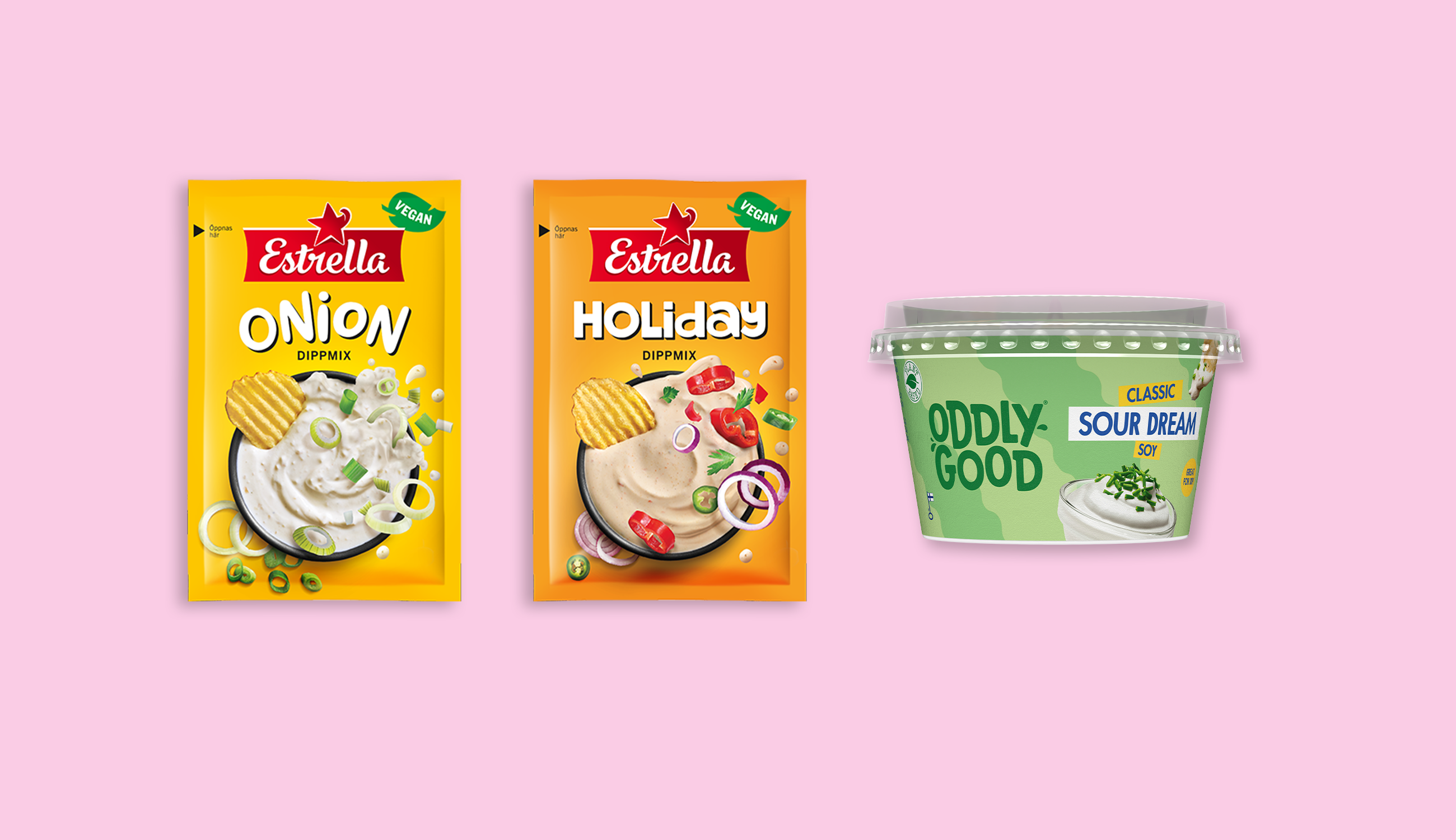 Två påsar dipp och en burk med vegansk fraiche mot en ljusrosa bakgund