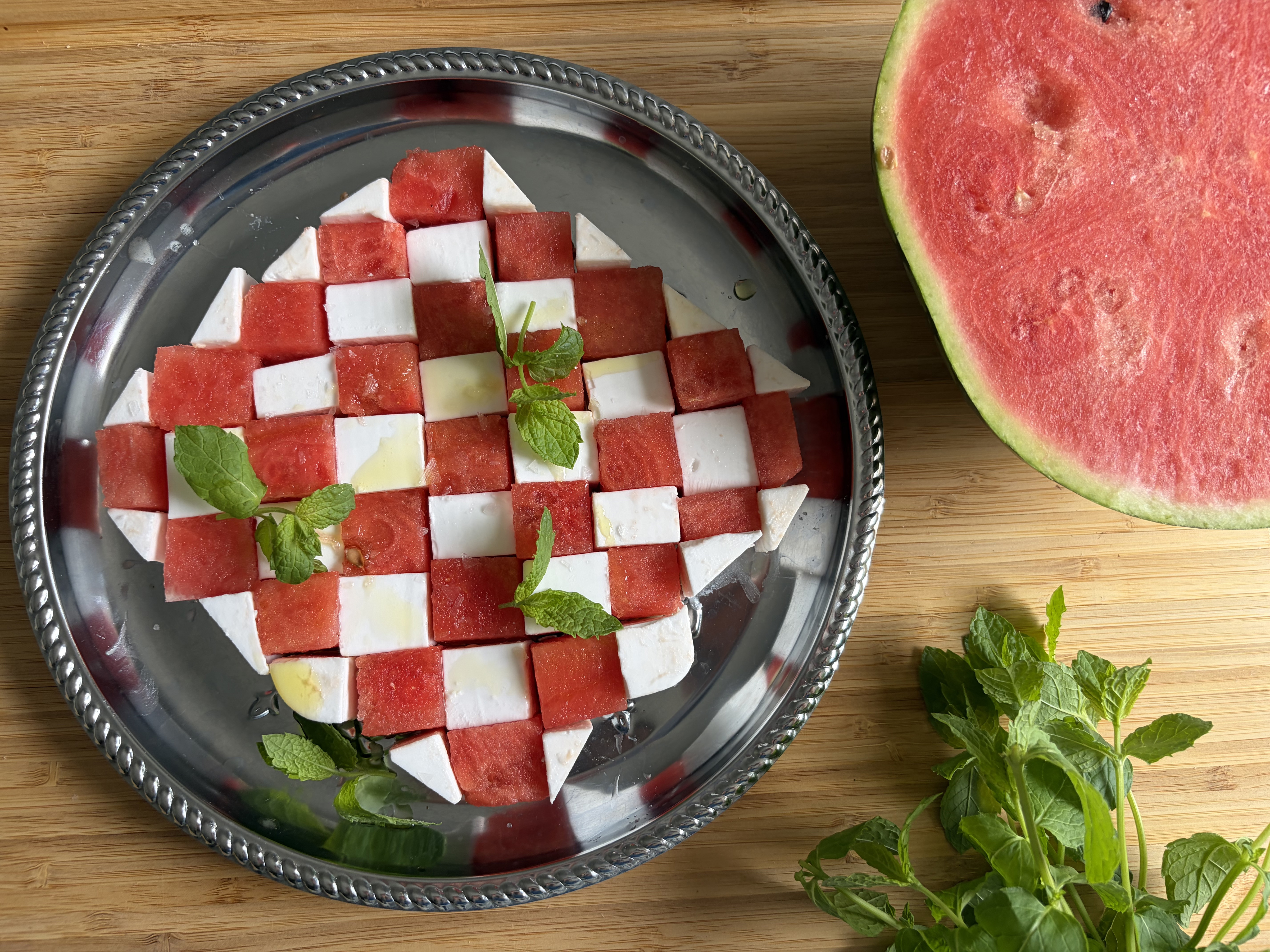 Plockbricka med fetaost och melon i ett schackmönster