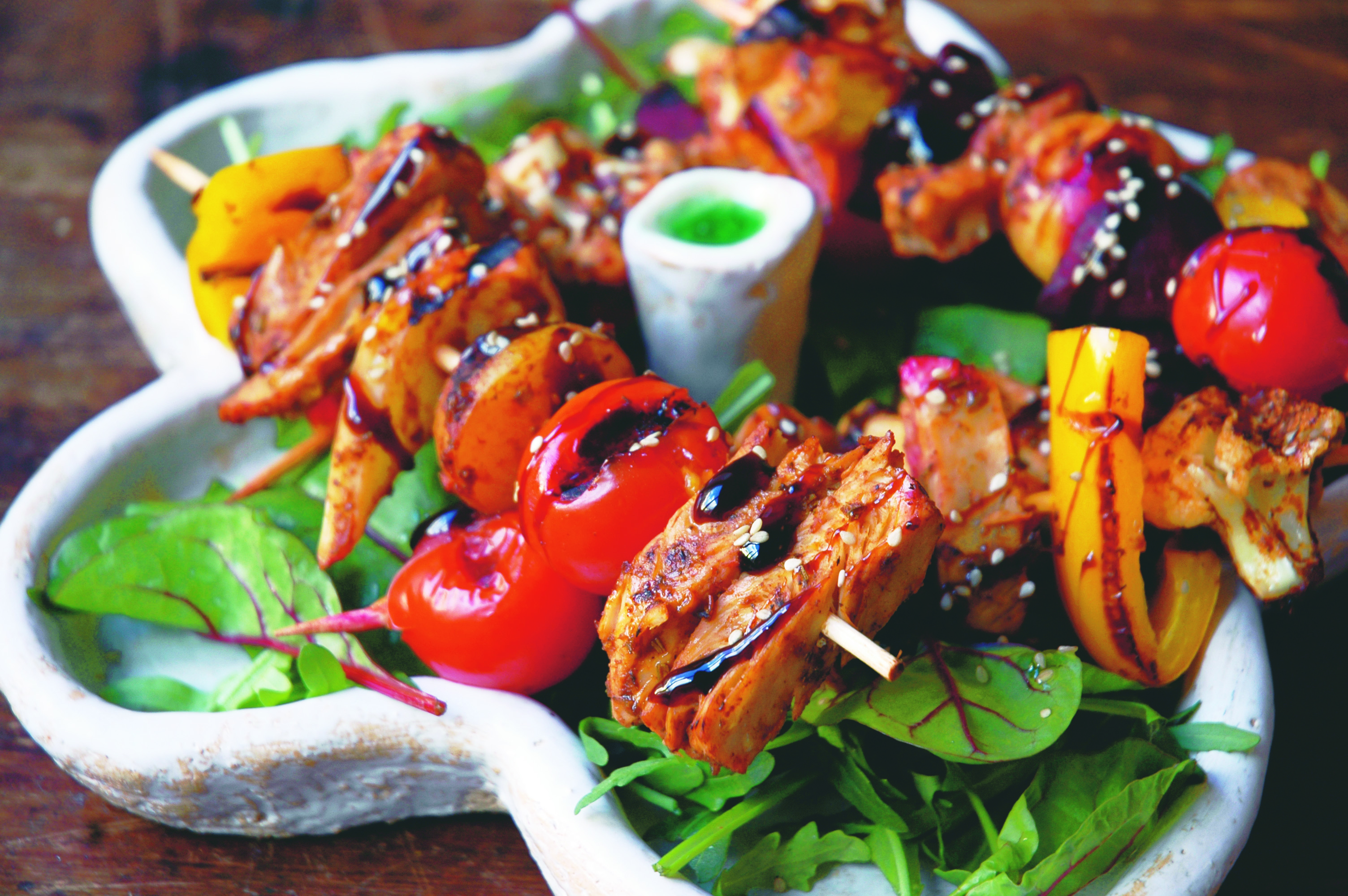 Grillspett i BBQ-marinad med sallad på ett vitt fat